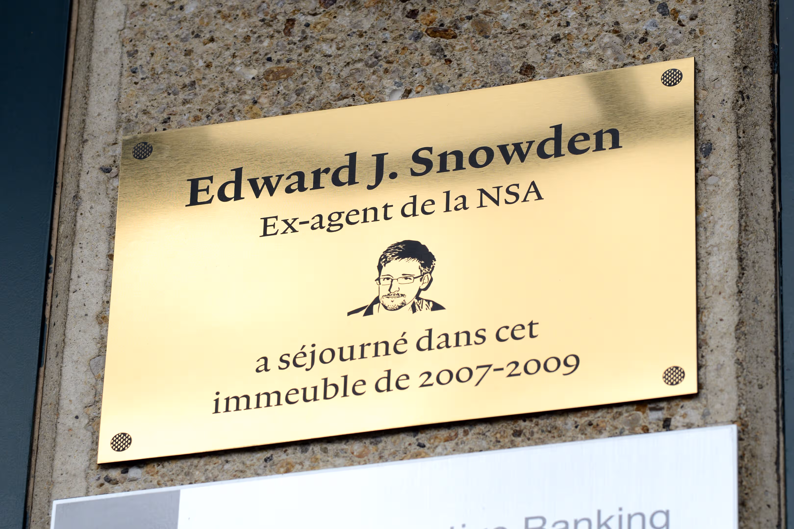 Commemorative plaque glued onto building's entrace